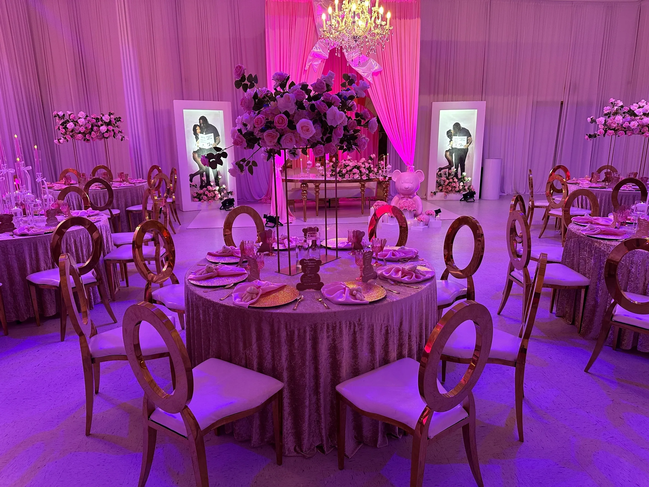 Opulent event setup with chandeliers and drapes